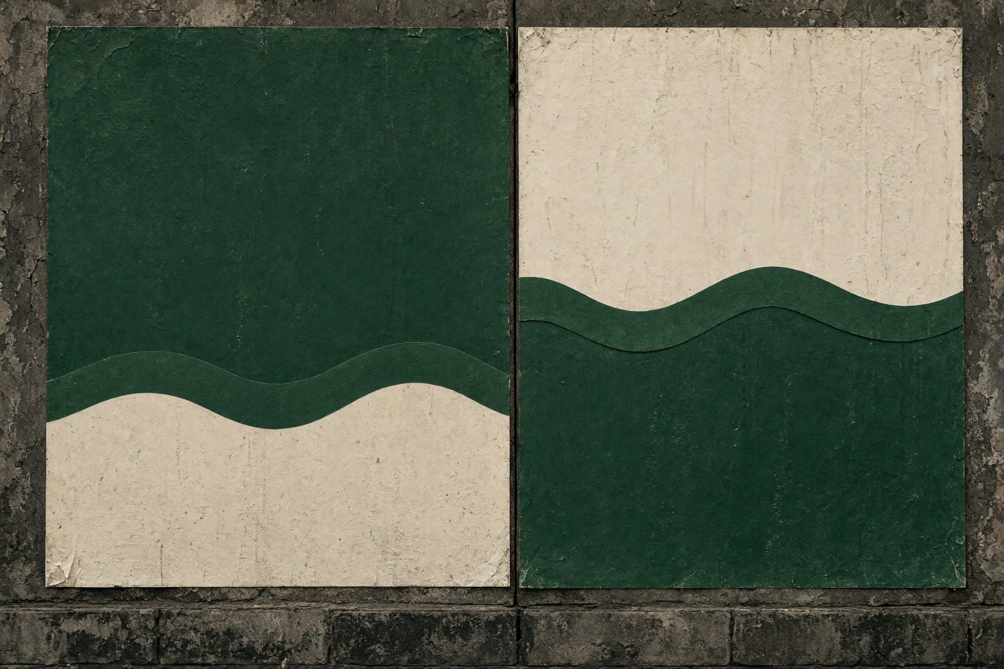 Two versions of one poster side by side on a wall